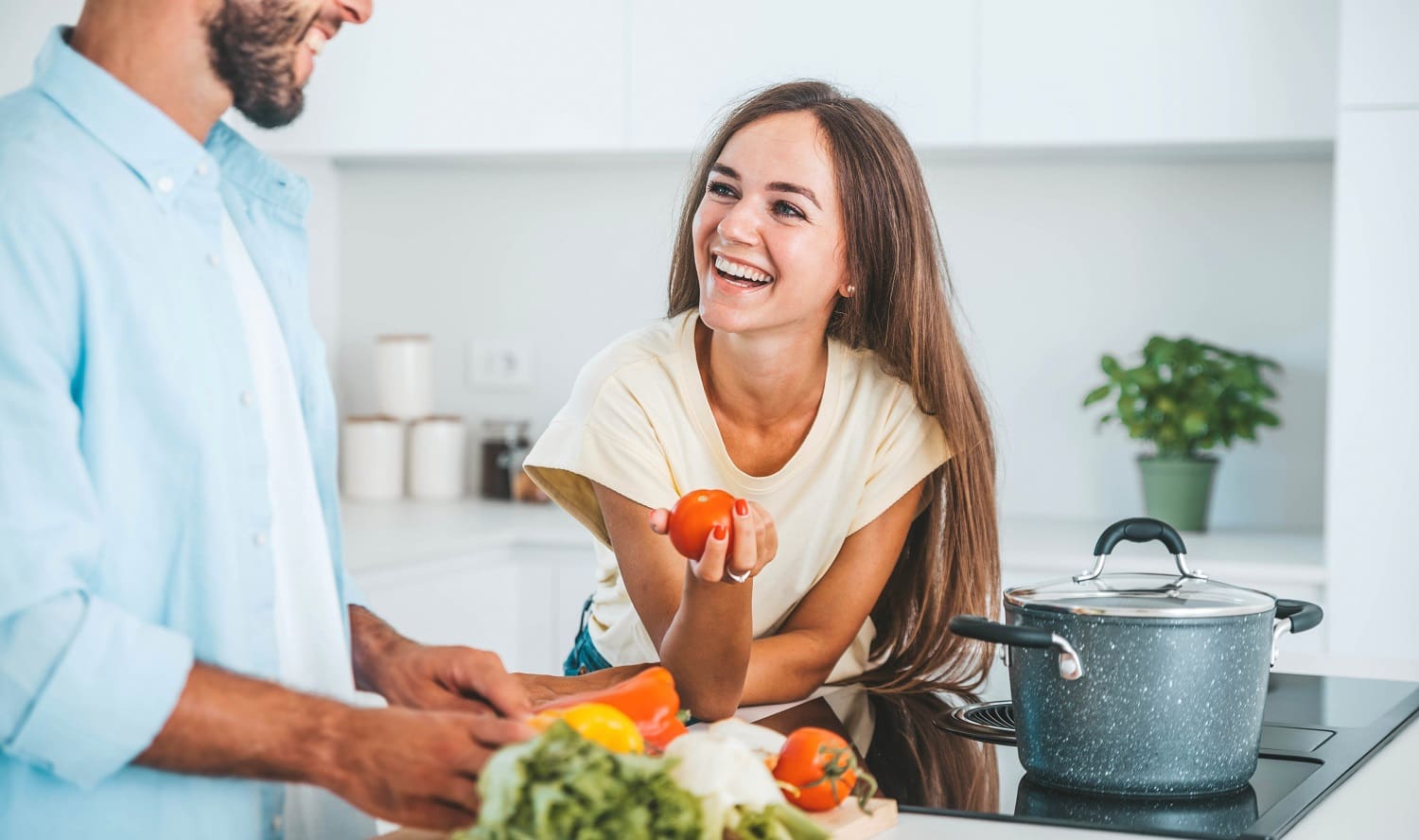 Couple preparing healthy meal in kitchen at home
