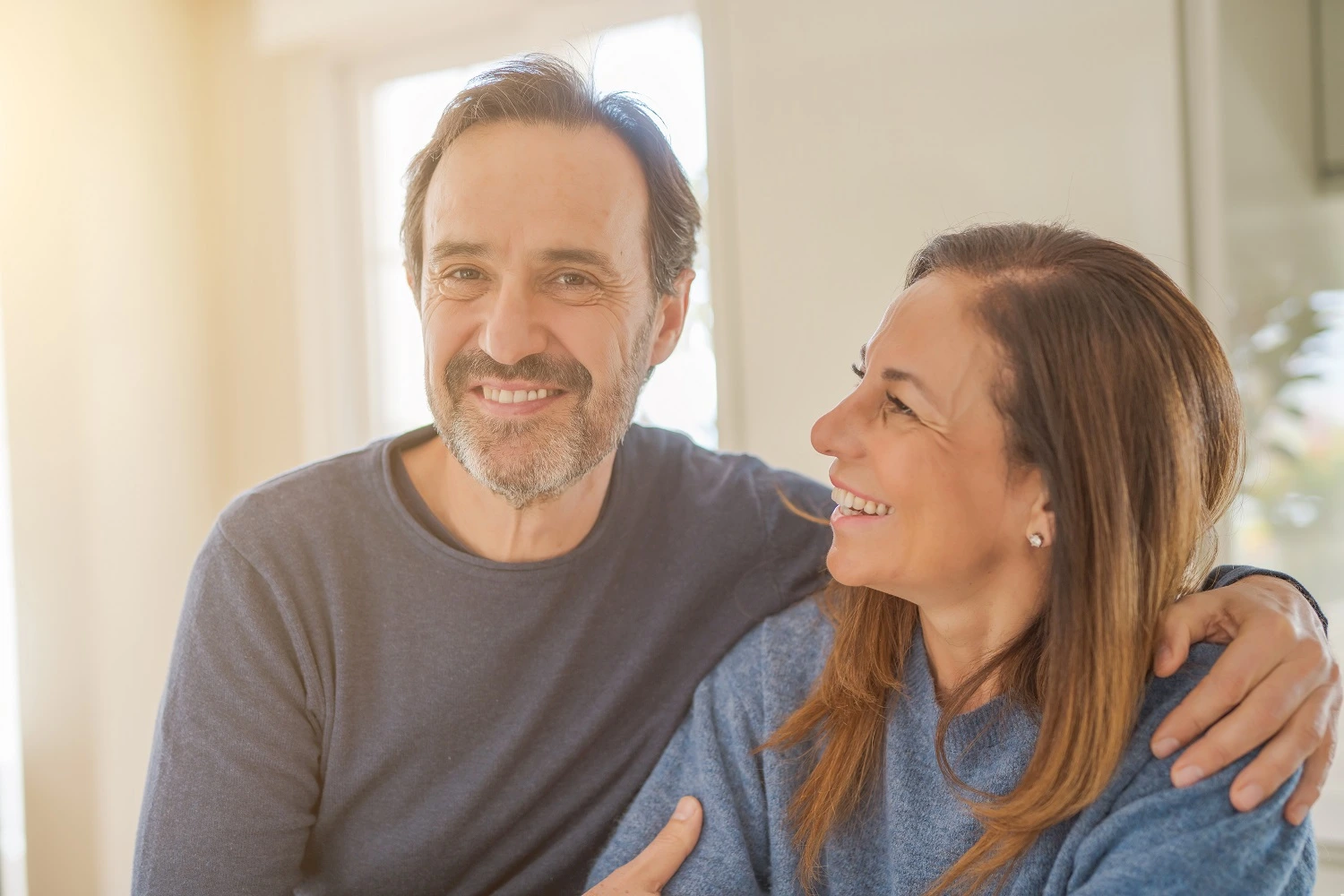 Middle age couple in the kitchen enjoying a healthy aging life