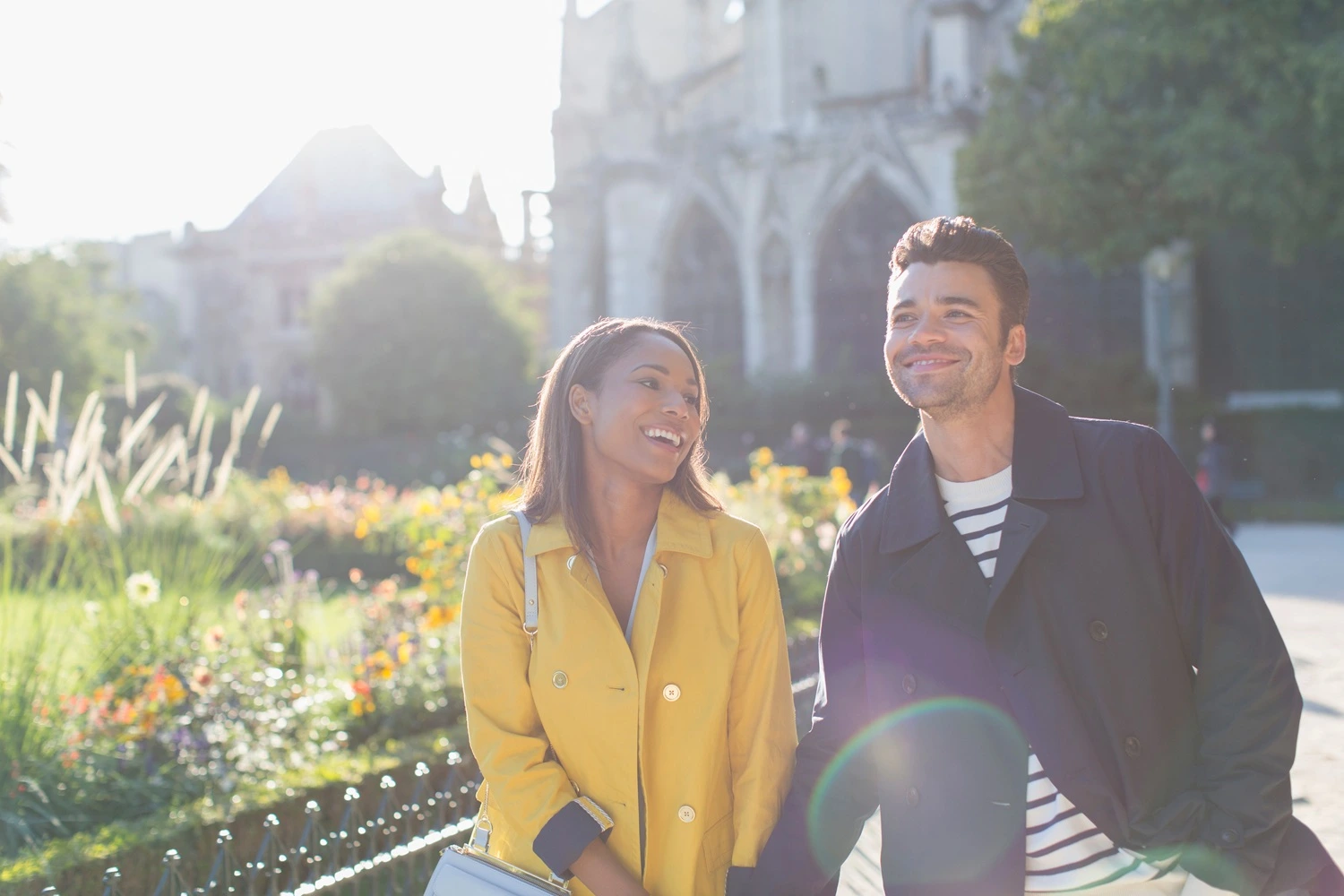 Happy couple smiling and walking in a park