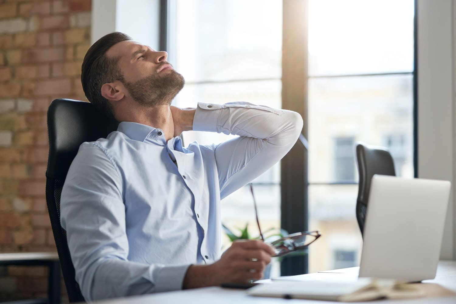 Man in the office feeling tired during work