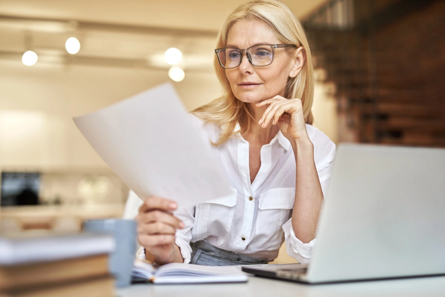 Woman reading documents during work in the office